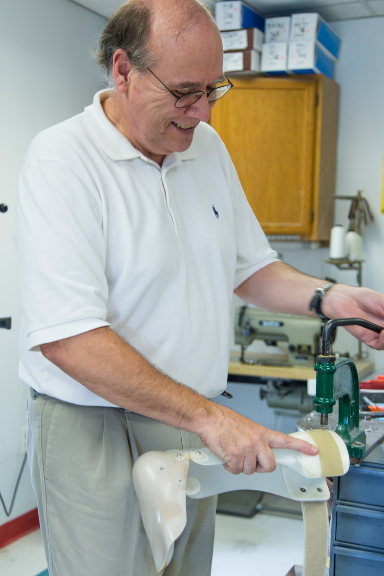 An on-site technician working on a prosthetic inside of our Fairfax facility