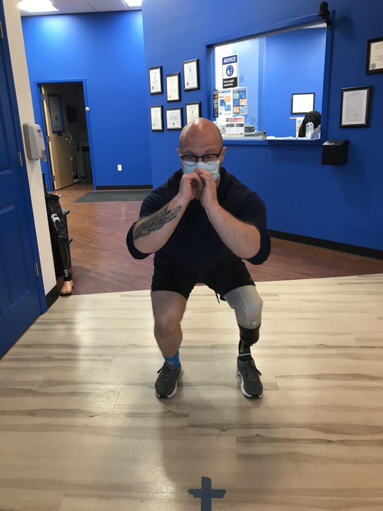 MCOP Boston client Nate exercising his new prosthetic leg in our Boston office