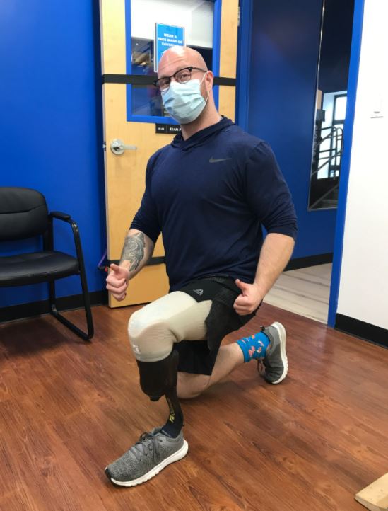 Boston client Nate kneeing down on his new leg prosthetic in our Boston clinic